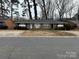 Brick triplex with a shared driveway and mature trees at 5009 Highlake Dr, Charlotte, NC 28215