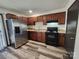 Modern kitchen with stainless steel appliances and wood cabinets at 5009 Highlake Dr, Charlotte, NC 28215