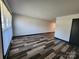 Living room featuring wood-look floors and a large window at 5009 Highlake Dr, Charlotte, NC 28215