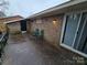 Simple concrete patio, brick wall, and sliding glass doors at 5009 Highlake Dr, Charlotte, NC 28215