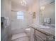 Bright bathroom with white tile, granite vanity, and a tub at 523 W 2Nd Ave, Gastonia, NC 28052