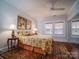 Bedroom with double bed, ceiling fan, and mirrored closet at 523 W 2Nd Ave, Gastonia, NC 28052