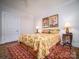 Bedroom with floral bedding and hardwood floors at 523 W 2Nd Ave, Gastonia, NC 28052