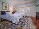 Bedroom with two twin beds, blue rug, and hardwood floors at 523 W 2Nd Ave, Gastonia, NC 28052