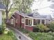 Red brick craftsman home with a driveway and mature trees at 523 W 2Nd Ave, Gastonia, NC 28052