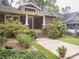 Charming red bungalow with landscaped front yard and walkway at 523 W 2Nd Ave, Gastonia, NC 28052