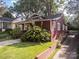 Charming red bungalow with landscaped yard and driveway at 523 W 2Nd Ave, Gastonia, NC 28052