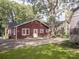 Red house exterior with large tree and paved area at 523 W 2Nd Ave, Gastonia, NC 28052