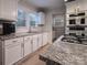 White kitchen with granite countertops and stainless steel appliances at 523 W 2Nd Ave, Gastonia, NC 28052