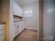 Bright laundry room with white cabinets and granite countertop at 523 W 2Nd Ave, Gastonia, NC 28052