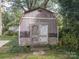 Rustic wooden shed with double doors in backyard at 523 W 2Nd Ave, Gastonia, NC 28052