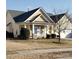 Ranch home with light yellow siding, gray roof, and a covered porch at 5375 Josephine Sw Ln, Concord, NC 28027