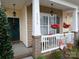 Inviting front porch with white railings and hanging flower baskets at 5375 Josephine Sw Ln, Concord, NC 28027