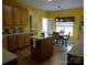 Kitchen boasts an island, wood cabinets, and a breakfast area at 5375 Josephine Sw Ln, Concord, NC 28027