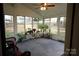 Bright sunroom with wicker chairs and many plants at 5375 Josephine Sw Ln, Concord, NC 28027