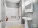 Bathroom with pedestal sink and shower/tub at 5435 Village Nw Dr, Concord, NC 28027