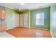 Dining area with wood floors and green walls, near kitchen at 5435 Village Nw Dr, Concord, NC 28027