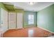 Light wood floors and green walls in the dining area at 5435 Village Nw Dr, Concord, NC 28027