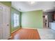 Dining area with green walls, wood floors and access to bathroom at 5435 Village Nw Dr, Concord, NC 28027