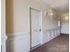 Clean hallway with white door and wall paneling at 5435 Village Nw Dr, Concord, NC 28027