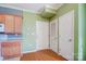 Kitchen with light wood cabinets, white appliances, and green walls at 5435 Village Nw Dr, Concord, NC 28027