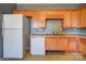 White appliances and light wood cabinets in kitchen at 5435 Village Nw Dr, Concord, NC 28027