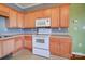 Close up of kitchen appliances and light wood cabinets at 5435 Village Nw Dr, Concord, NC 28027