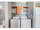 Bright laundry room, washer, dryer, and shelving at 5435 Village Nw Dr, Concord, NC 28027