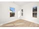 Well-lit bedroom with hardwood floors and three windows at 602 York Ave, Statesville, NC 28677