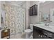 Bathroom featuring a single sink vanity, floral shower curtain, and matching cabinet at 645 Honey Dew Ln, Fort Mill, SC 29715