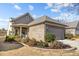 Charming home exterior featuring stone accents, a two-car garage, and well-manicured landscaping at 645 Honey Dew Ln, Fort Mill, SC 29715