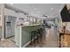 Stylish kitchen featuring an island with bar seating, stainless steel appliances, and a clear view of the dining area at 645 Honey Dew Ln, Fort Mill, SC 29715