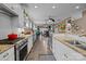 Efficient kitchen layout with granite counters, stainless appliances, and a view into the dining area and beyond at 645 Honey Dew Ln, Fort Mill, SC 29715