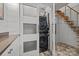 Laundry room with a stacked washer and dryer, adjacent to floating stairs at 645 Honey Dew Ln, Fort Mill, SC 29715