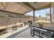 Outdoor patio area featuring awning, stone wall, and cozy seating for outdoor relaxation at 645 Honey Dew Ln, Fort Mill, SC 29715