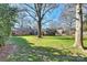 Large backyard with mature trees and a spacious lawn at 6511 Newhall Rd, Charlotte, NC 28270