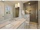 Modern bathroom with a large walk-in shower and marble finishes at 6511 Newhall Rd, Charlotte, NC 28270