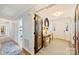 Light and airy entryway with a unique reclaimed wood door and console table at 6511 Newhall Rd, Charlotte, NC 28270