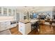 Bright kitchen boasts a large island, white cabinets, and views into the living room at 6511 Newhall Rd, Charlotte, NC 28270