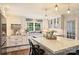 Updated kitchen with white cabinetry, marble countertops, and stylish pendant lighting at 6511 Newhall Rd, Charlotte, NC 28270