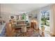 Living area with hardwood floors, large windows, and a colorful rug at 6511 Newhall Rd, Charlotte, NC 28270