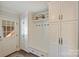 Functional mudroom with built-in bench, cabinets, and coat hooks at 6511 Newhall Rd, Charlotte, NC 28270