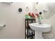 Small bathroom with pedestal sink, mirror and toilet at 6908 Agava Ln, Charlotte, NC 28215