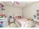 bedroom featuring a pink bed, dresser and decor at 6908 Agava Ln, Charlotte, NC 28215