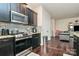 Modern kitchen with dark cabinetry and stainless steel appliances at 6908 Agava Ln, Charlotte, NC 28215