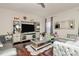 Living room with hardwood floors, sectional sofa, and entertainment center at 6908 Agava Ln, Charlotte, NC 28215