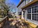 Spacious back deck with wooden railings, overlooking a wooded area at 7780 Orchard Park Cir, Harrisburg, NC 28075