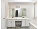 Bathroom with double vanity and garden tub at 7780 Orchard Park Cir, Harrisburg, NC 28075