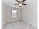 Bright bedroom with ceiling fan and carpet at 7780 Orchard Park Cir, Harrisburg, NC 28075