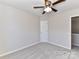 Bedroom with ceiling fan and door to hallway at 7780 Orchard Park Cir, Harrisburg, NC 28075